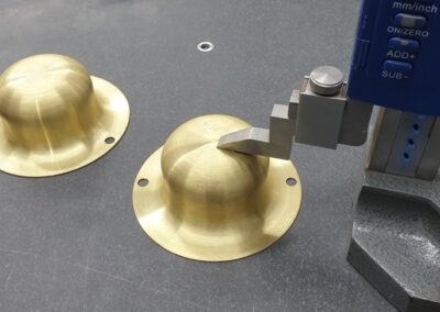 Aerospace brass spinning being quality checked at HSM Engineering Ltd